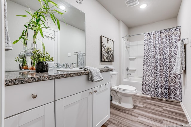 full bathroom featuring vanity, toilet, hardwood / wood-style floors, and shower / bath combo