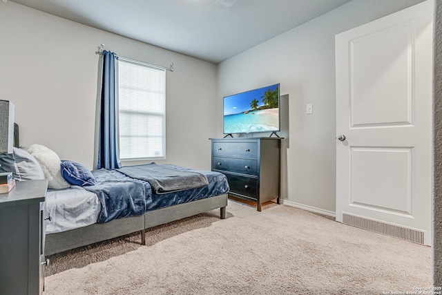 bedroom featuring light colored carpet