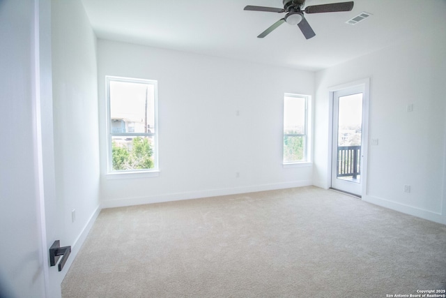 1255 Canyon Lk, Canyon Lake, TX 78133 - empty room featuring plenty of natural light, ceiling fan, carpet flooring, and baseboards