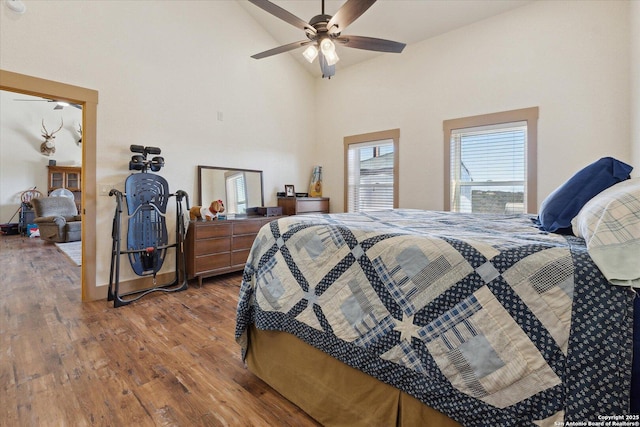 bedroom with lofted ceiling, hardwood / wood-style floors, and ceiling fan