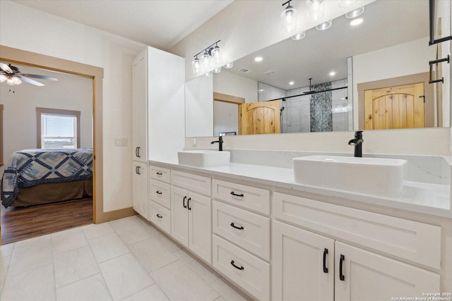 bathroom featuring ceiling fan, vanity, a shower with door, and tile patterned flooring