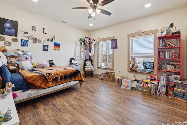 bedroom with ceiling fan and wood-type flooring