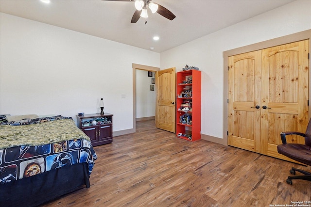 bedroom with ceiling fan and wood-type flooring