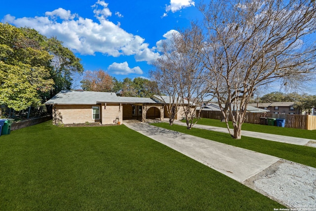 ranch-style home with a front yard