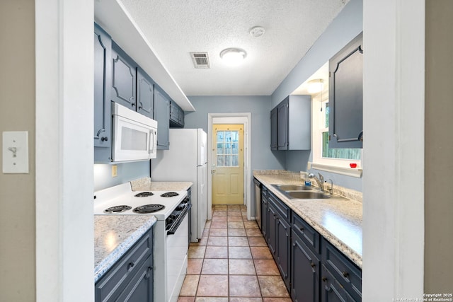 kitchen featuring sink, a textured ceiling, light tile patterned floors, white appliances, and light stone countertops