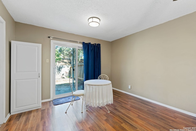 sitting room with dark hardwood / wood-style floors and a textured ceiling