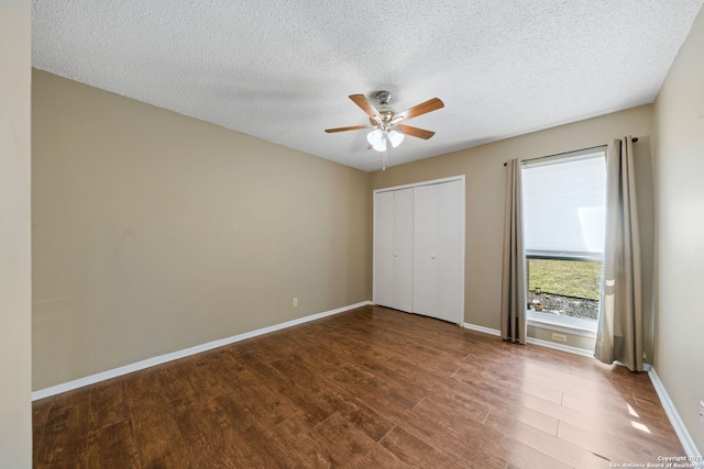 unfurnished bedroom featuring hardwood / wood-style floors, a textured ceiling, a closet, and ceiling fan