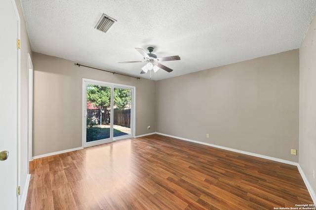 spare room featuring ceiling fan, hardwood / wood-style floors, and a textured ceiling