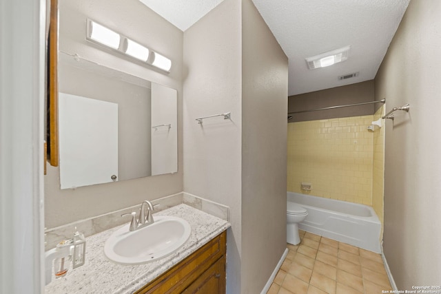 full bathroom featuring tiled shower / bath, tile patterned flooring, vanity, toilet, and a textured ceiling