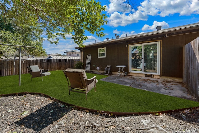 rear view of house featuring a yard and a patio area