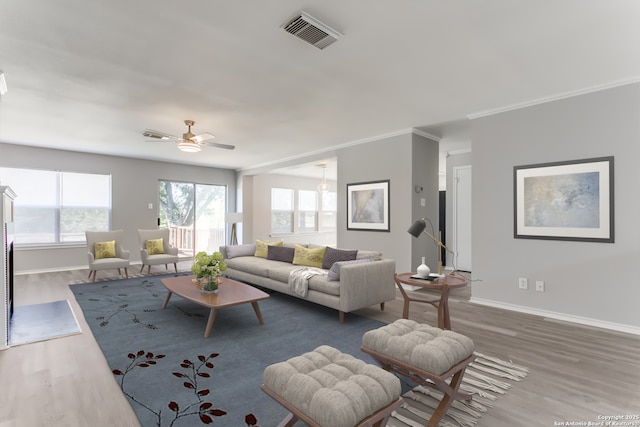 living room with ornamental molding, dark wood-type flooring, and ceiling fan