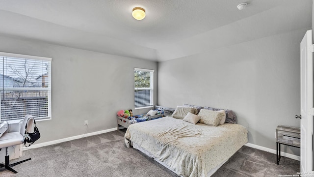 carpeted bedroom with lofted ceiling