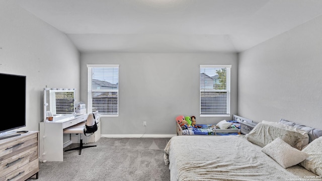 bedroom with vaulted ceiling and light colored carpet