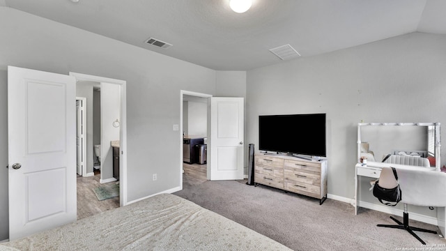 carpeted bedroom featuring vaulted ceiling