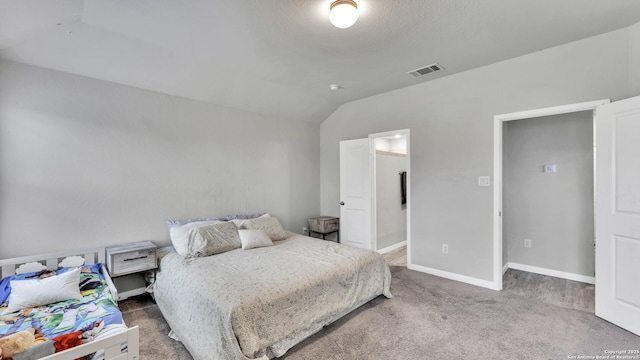 bedroom with lofted ceiling and carpet flooring