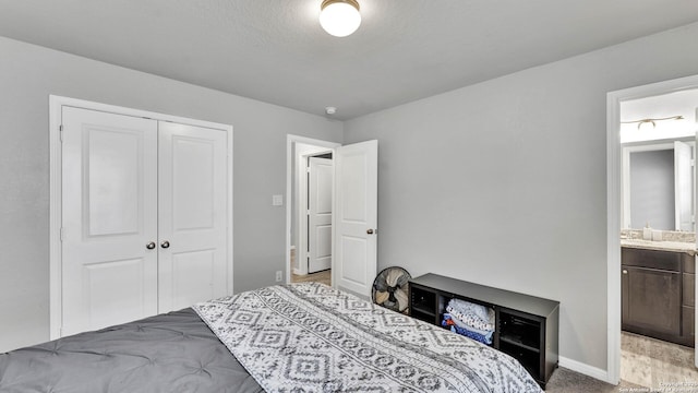 bedroom featuring ensuite bath and a closet