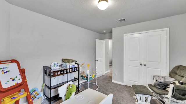 game room featuring carpet and a textured ceiling