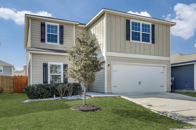 view of property featuring a garage and a front lawn