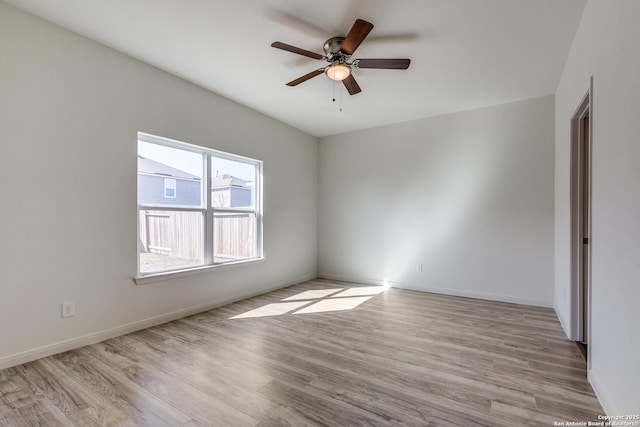 unfurnished room with ceiling fan and light wood-type flooring