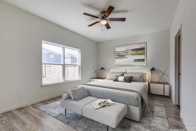 bedroom featuring ceiling fan and light hardwood / wood-style flooring