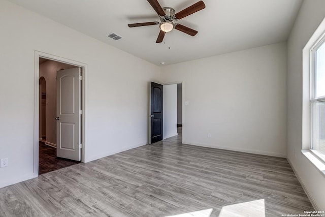 unfurnished bedroom featuring ceiling fan and light wood-type flooring