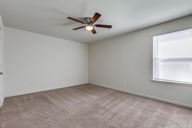 carpeted spare room with ceiling fan