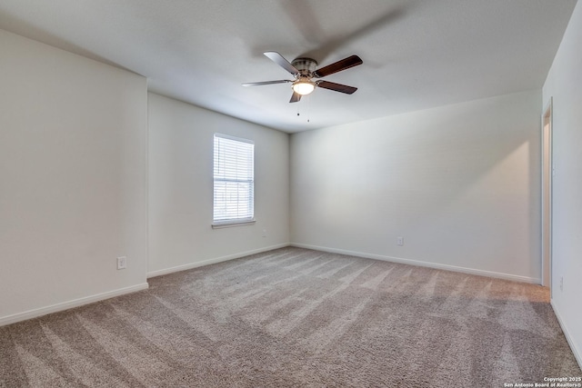 unfurnished room with ceiling fan and carpet