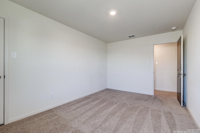 empty room featuring light colored carpet