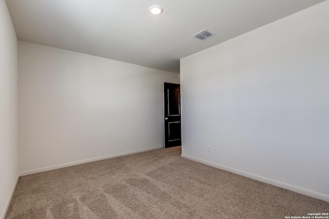 unfurnished room featuring light colored carpet