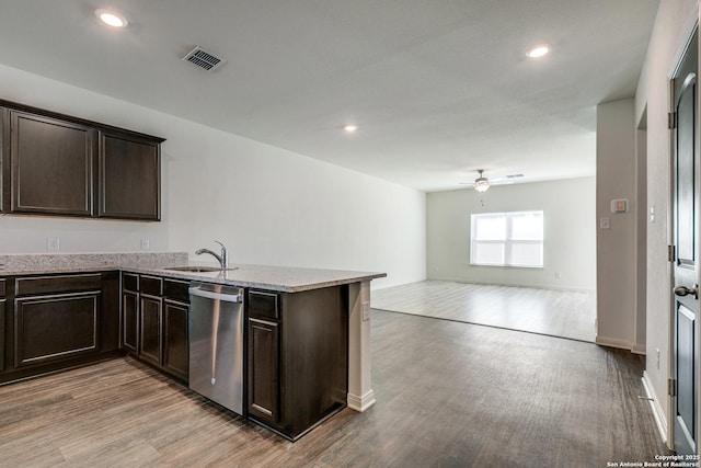 kitchen featuring sink, dishwasher, dark brown cabinetry, kitchen peninsula, and light wood-type flooring