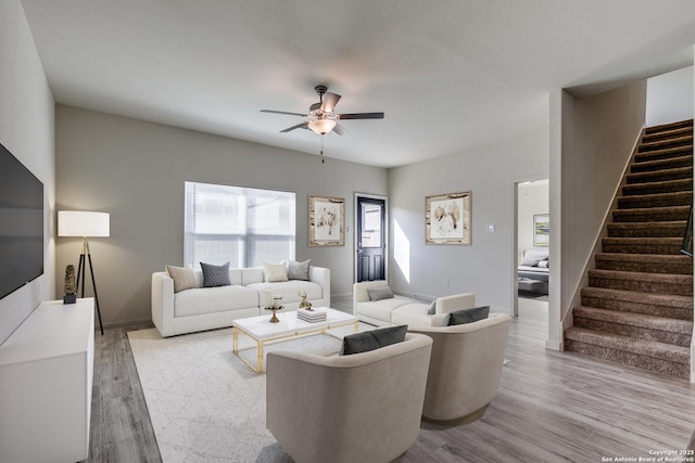 living room featuring ceiling fan and light hardwood / wood-style flooring