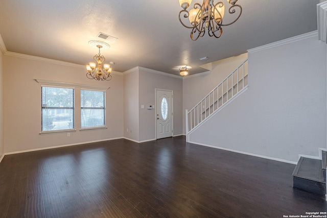 entrance foyer with a notable chandelier, crown molding, and dark hardwood / wood-style floors