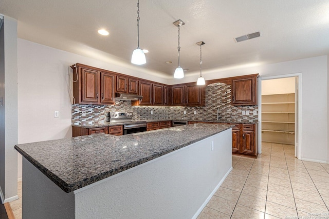 kitchen featuring hanging light fixtures, light tile patterned floors, a kitchen island, stainless steel appliances, and decorative backsplash