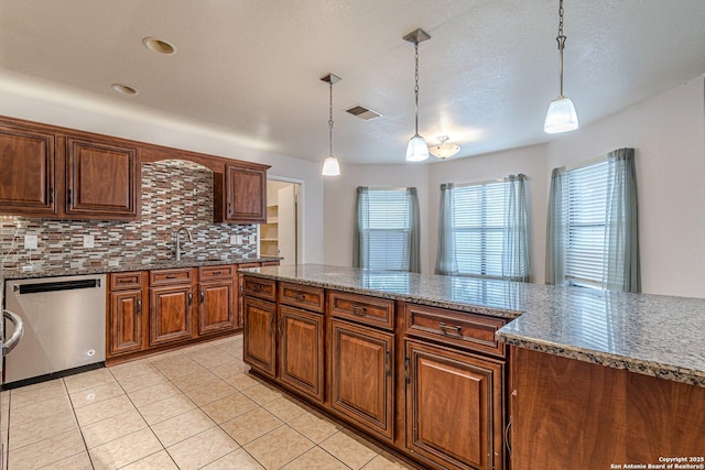 kitchen featuring tasteful backsplash, pendant lighting, stainless steel dishwasher, and light tile patterned flooring