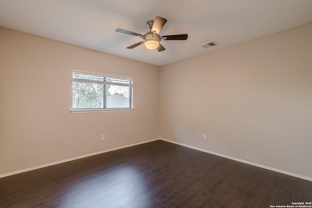 spare room featuring ceiling fan, dark hardwood / wood-style flooring, and a textured ceiling