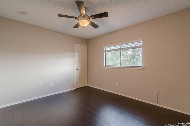 spare room with a textured ceiling, dark hardwood / wood-style floors, and ceiling fan