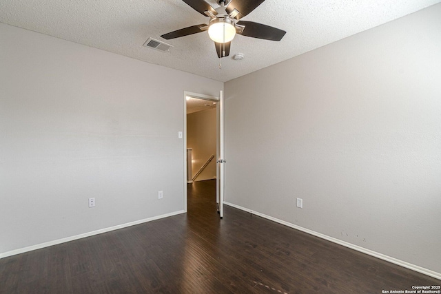 unfurnished room featuring dark hardwood / wood-style flooring, ceiling fan, and a textured ceiling