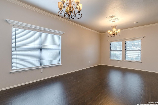 empty room with ornamental molding, plenty of natural light, and an inviting chandelier