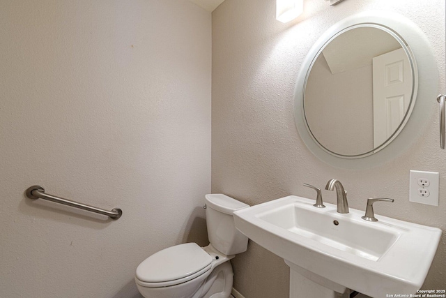 bathroom with sink and toilet