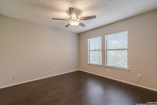 empty room featuring dark hardwood / wood-style floors, a textured ceiling, and ceiling fan