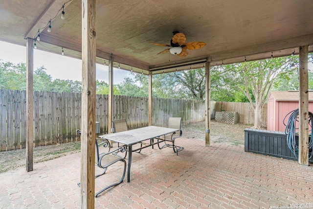 view of patio / terrace with ceiling fan and a shed