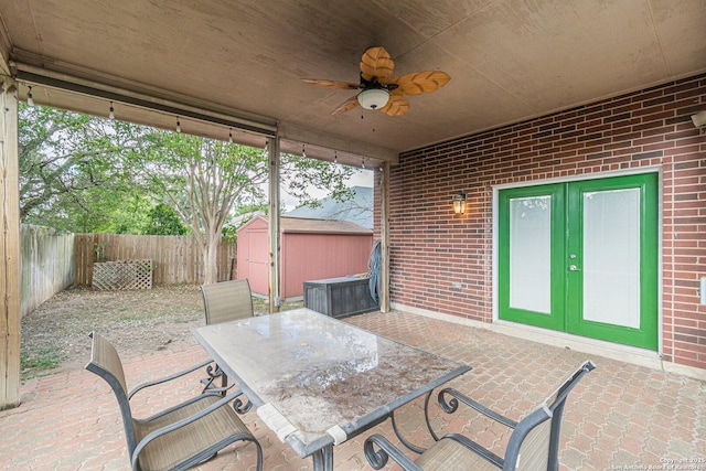 view of patio with a storage shed, french doors, and ceiling fan