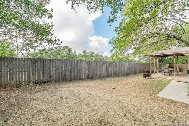 view of yard with a gazebo, a patio area, and a fire pit