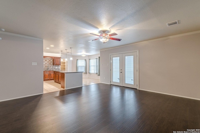 unfurnished living room with light hardwood / wood-style flooring, ornamental molding, french doors, and ceiling fan