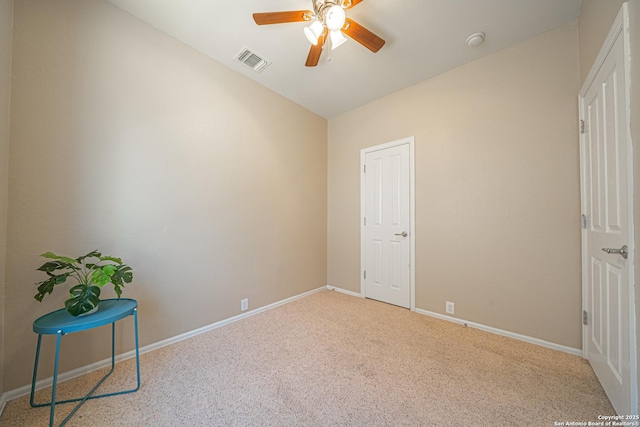 carpeted spare room with ceiling fan and vaulted ceiling