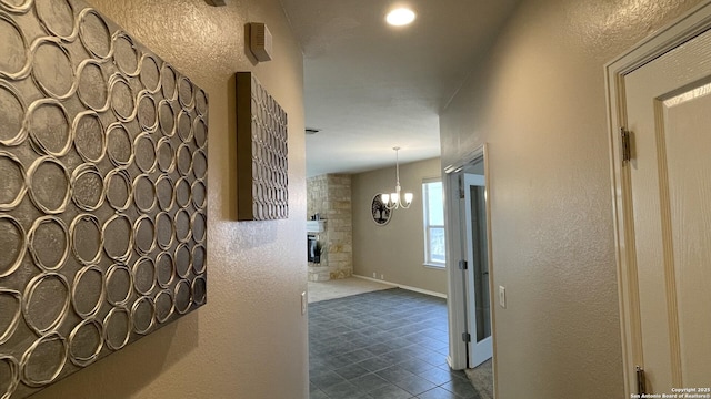 corridor featuring a notable chandelier