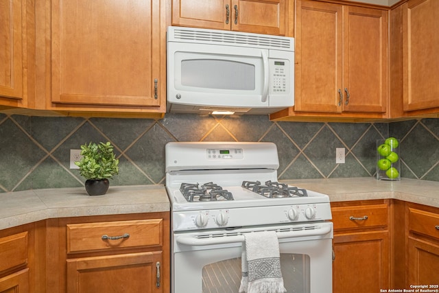 kitchen featuring white appliances and decorative backsplash