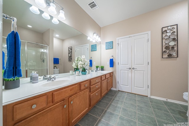 bathroom featuring vanity, toilet, and an enclosed shower