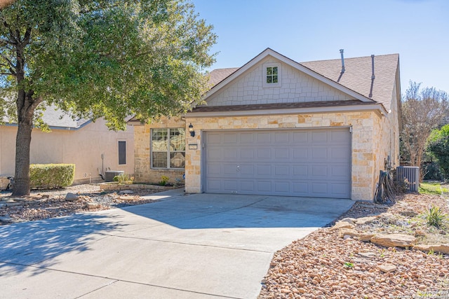 view of front of property with a garage and central AC