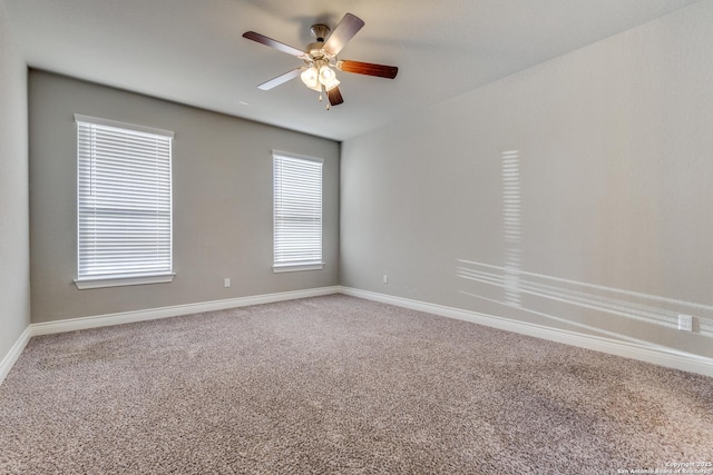 empty room with ceiling fan and carpet flooring